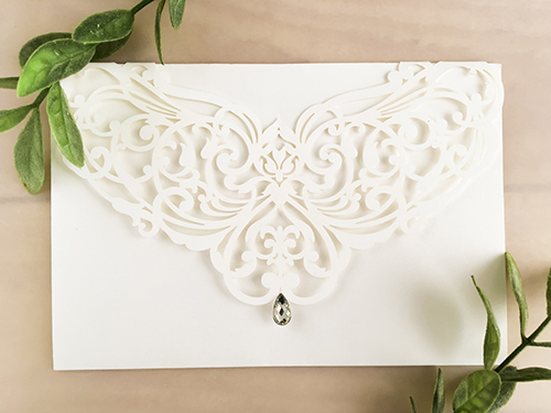 Invitation lc90: Ivory Shimmer - This is a simple ivory shimmer laser cut wedding invitation.  There is a rhinestone jewel on the cover.