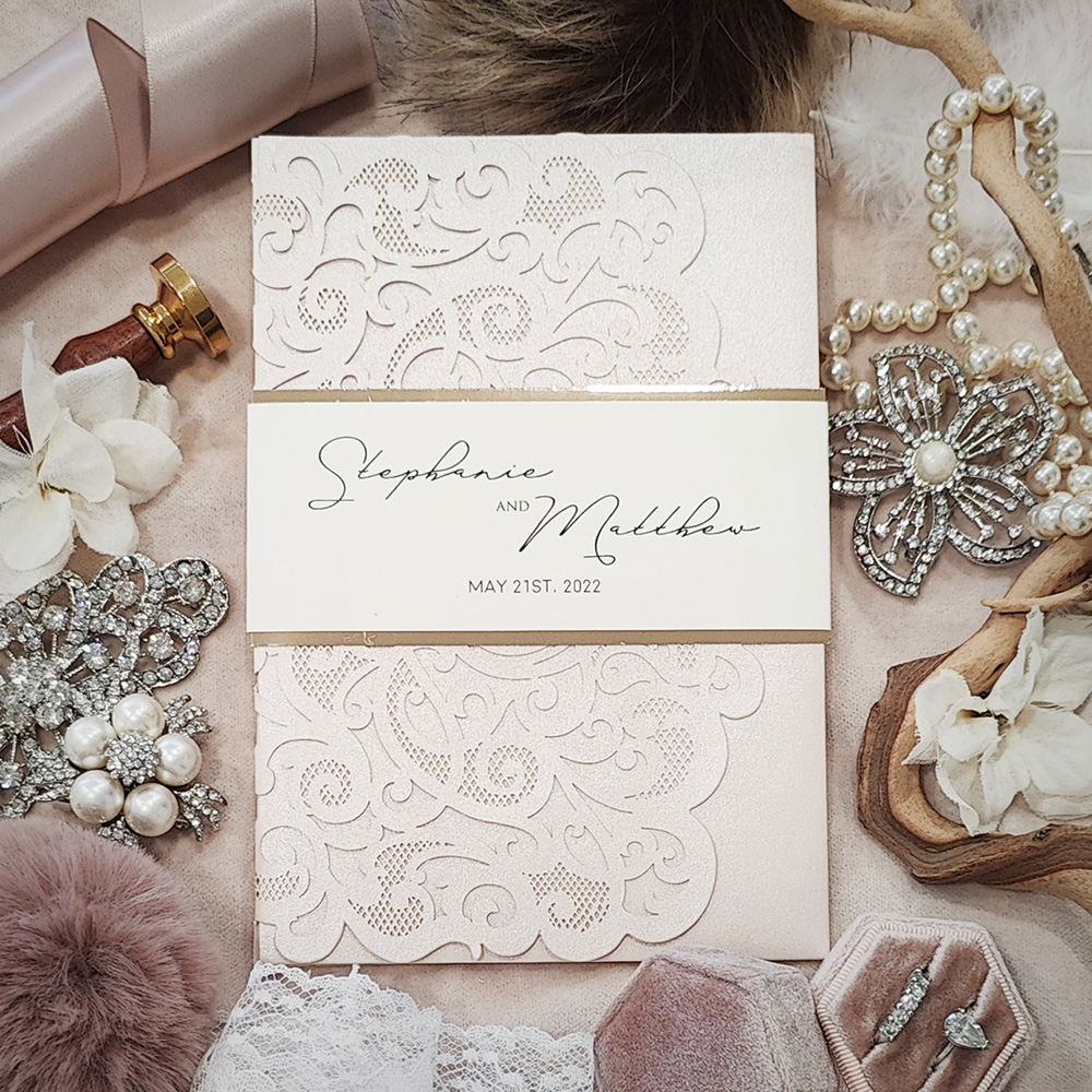 Invitation 8002: Blush Shimmer, Gold Mirror, Cream Smooth - pocketfold lasercut with printed backed cardstock band