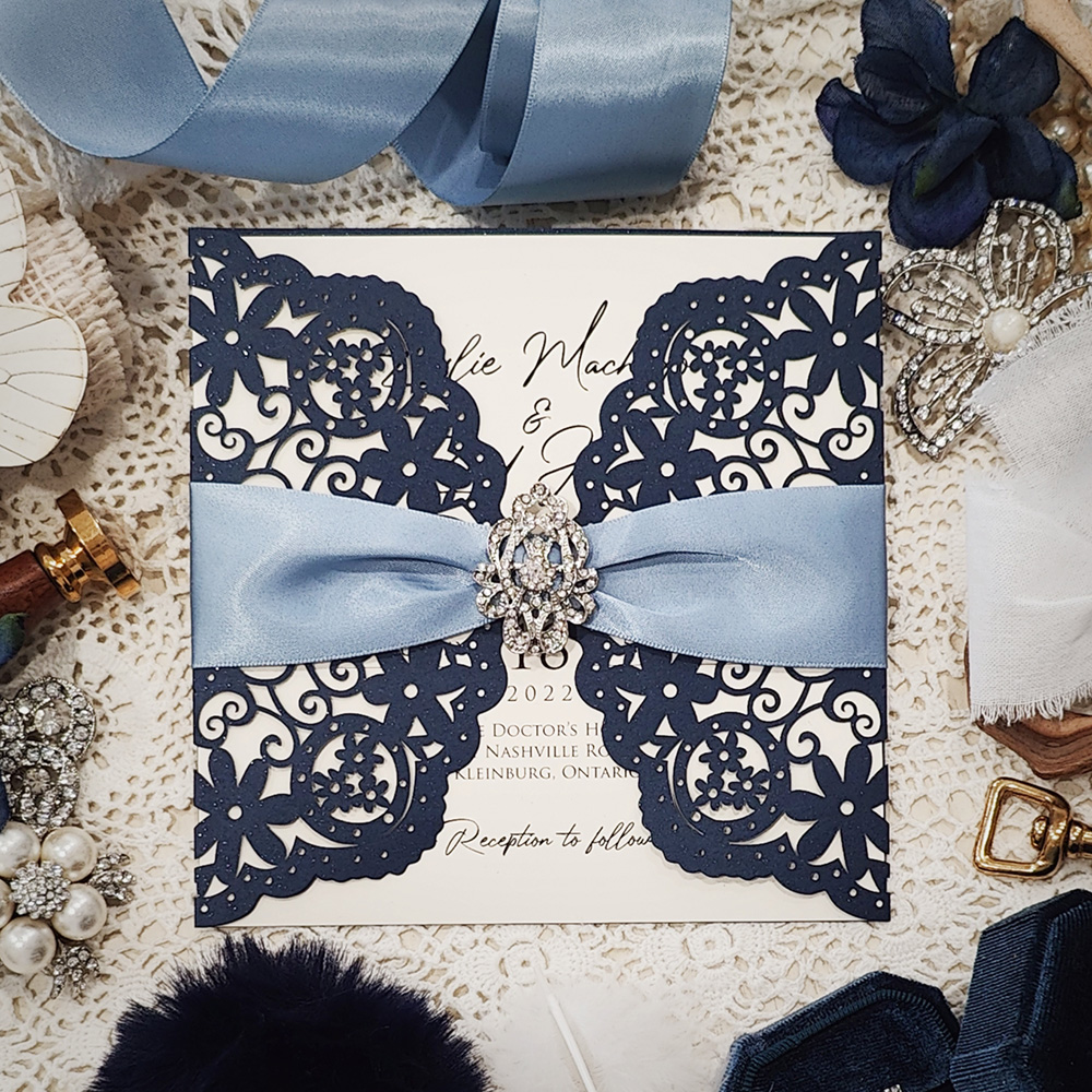 Invitation 8005: Glittering Navy, Cream Smooth, Blue Mist Ribbon, Brooch/Buckle A10 - navy lasercut with blue mist ribbon and brooch