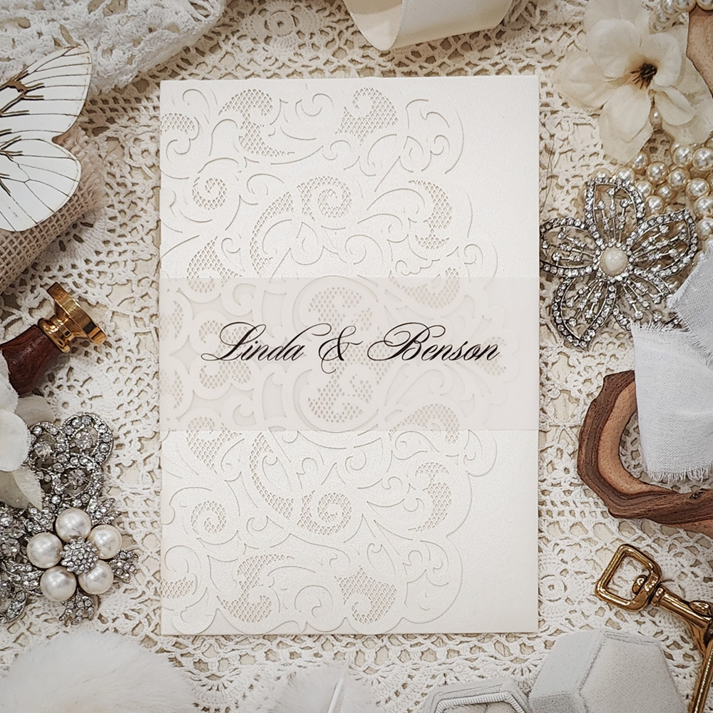 Invitation 8011: Ivory Shimmer, Cream Smooth - ivory pocketfold lasercut with vellum band and custom wreath monogram