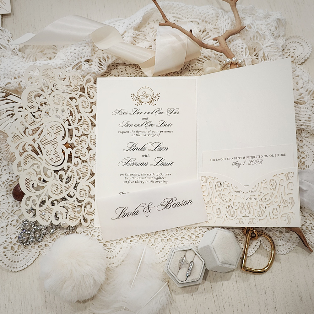 Invitation 8011: Ivory Shimmer, Cream Smooth - ivory pocketfold lasercut with vellum band and custom wreath monogram