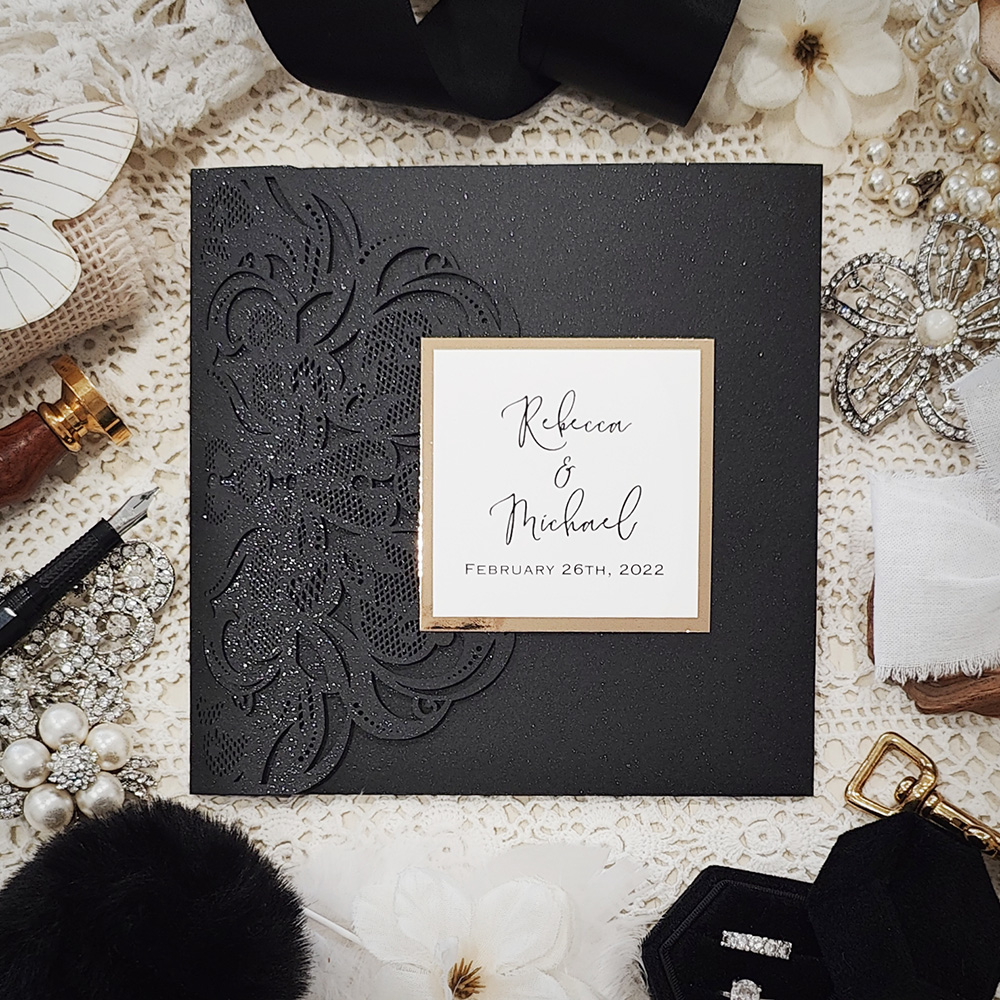 Invitation 8017: Glittering Black, Gold Mirror, White Smooth, White Ribbon - Black pocketfold lasercut with layered tag