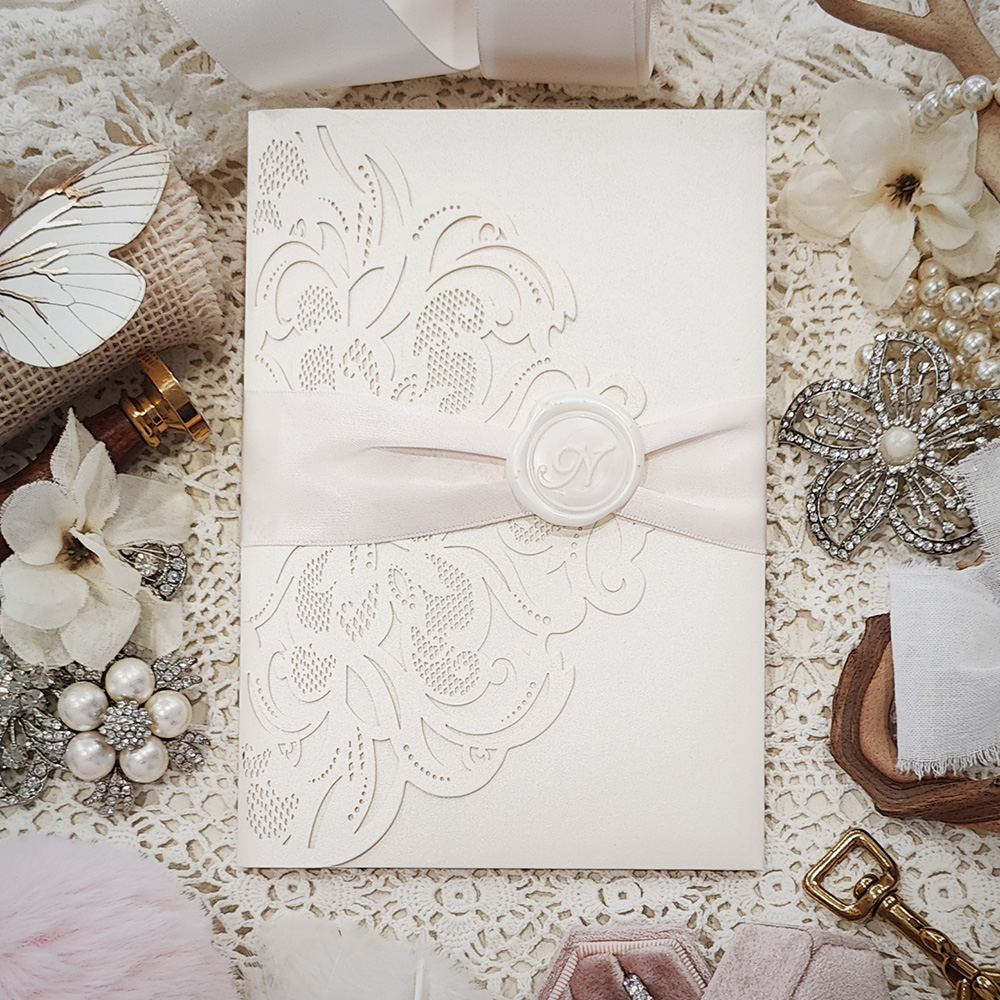 Invitation 8038: Ivory Shimmer, Cream Smooth, Ivory Wax, Petal Pink Ribbon - Ivory pocketfold lasercut with ribbon and wax seal