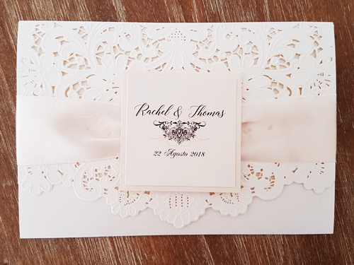 Invitation mb15: Ivory Shimmer, White Gold, Cream Smooth, Antique Ribbon - This is a pocket style laser cut in the ivory shimmer color shade.  There is an antique ribbon with a white gold layered cover tag.