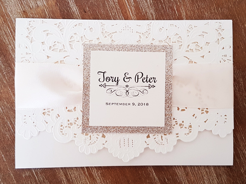 Invitation mb21: Ivory Shimmer, Champagne Glitter, Antique Ribbon - This is an ivory shimmer color paper laser cut invitation.  It has a pinched antique ribbon with a champagne glitter layered cover tag.