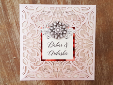 Invitation mb24: Blush Shimmer, Rose Gold Mirror, Cream Smooth, Brooch/Buckle X, Metal Filigree F4 - Silver - This is a square shaped four flap laser cut invite in blush shimmer.  There is a layered cover tag and combo brooch glued to the cover tag.