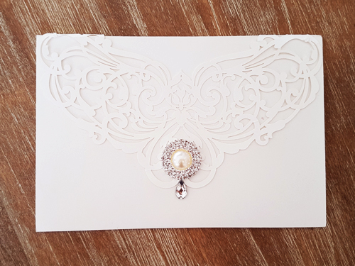 Invitation mb26: White, Brooch/Buckle G - This is a white colored laser cut wedding design.  There is a rhinestone jewel on the flap.  Also an extra pearl brooch.