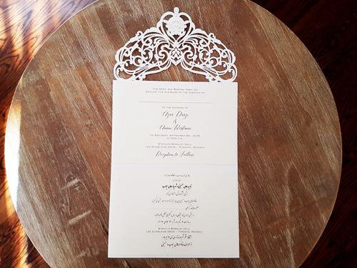 Invitation mb26: White, Brooch/Buckle G - This is a white colored laser cut wedding design.  There is a rhinestone jewel on the flap.  Also an extra pearl brooch.