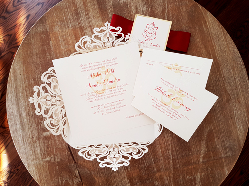 Invitation mb5: Ivory Shimmer, Gold Mirror, Cream Smooth, Sherry Ribbon - This is a popular square four flap laser cut design.  There is a sherry red ribbon wrapped around the invite and a layered cover tag.