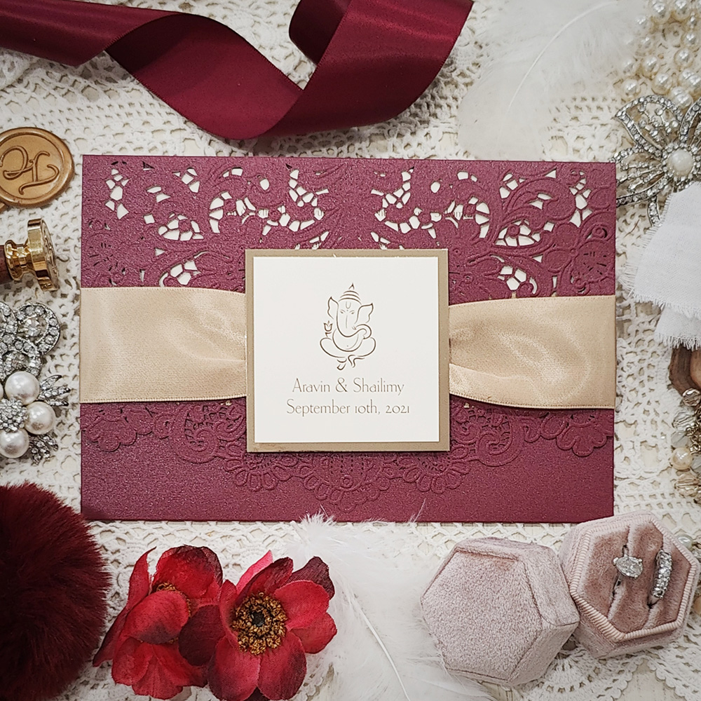 Invitation 8102: Burgundy Shimmer, Gold Mirror, Cream Smooth, Champagne Ribbon - Burgundy Ganesh bifold pocket lasercut with ribbon and layered tag