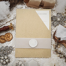 Invitation 3405: Gold Pearl, Cream Smooth, Ivory Wax - Gold pocket style wedding invitation with a vellum belly band and ivory wax seal.