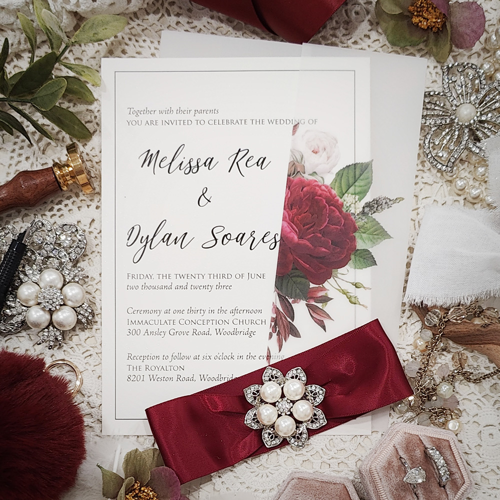 Invitation 3205: White Gold, Sherry Ribbon, Brooch/Buckle T - Single card wedding invite with a printed floral vellum wrap.  There is a ribbon and brooch combo wrapped around the card.