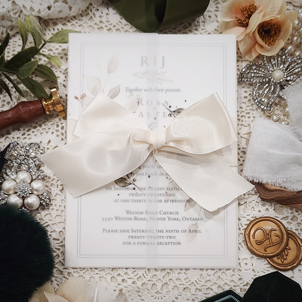 Invitation 3216: White Gold, Antique Ribbon - Single card invitation on white gold with a clear vellum wrap and antique bow.