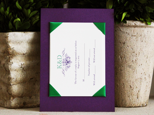 Invitation 776: Purple Pearl, Cream Smooth, Purple Ribbon, Purple Ribbon, Emerald Ribbon, Brooch/Buckle F - Layered invitation with a purple backing and criss cross purple and emerald detail with a small brooch